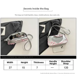 Detailed size chart for silver heart cut-out handbag showing 27x15x7cm dimensions
