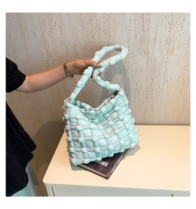 Close-up of mint green quilted tote bag with a trendy checkered puff fabric design