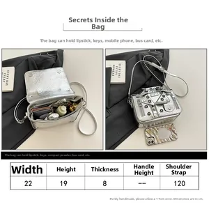 Size chart and capacity detail of a silver biker style crossbody bag with metal rivets