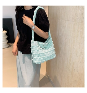 Close-up of mint green bubble texture bag showing the 3D puff lattice weave and strap