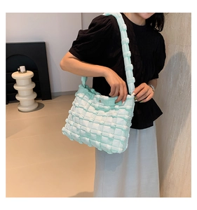 Detail of light blue bubble texture tote bag with stylish pleated pattern and wide strap