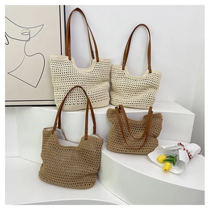 Detail of hollow woven cotton tote bags with leather straps on a minimalist display