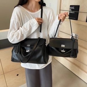Minimalist black leather shoulder bag with silver turn-lock in large and small sizes