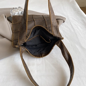Vintage dark brown textured leather tote bag with grid pattern and zipper detail