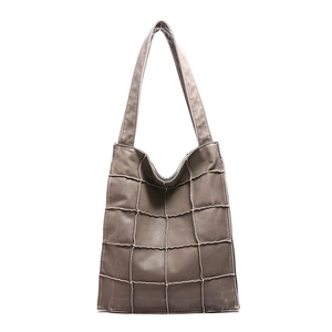 Gray large capacity tote bag with quilted pattern and white stitching on a white background