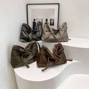 Minimalist soft leather tote bags in four retro colors displayed on a white platform