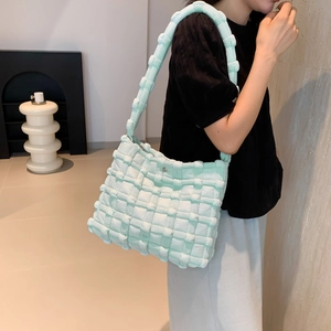 Modern light green puff shoulder bag shown on model highlighting the size and texture