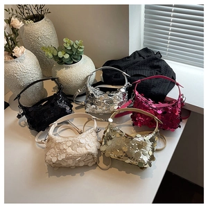 Close-up of sequined crescent handbags in multiple colors with metallic finish detail