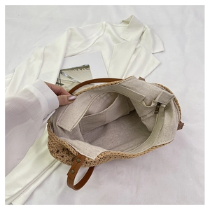 Detailed interior of woven beach bag showing linen lining with a secure zipper pocket