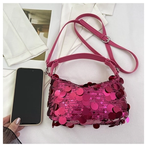 Detailed top view of fuchsia sequin shoulder bag with smartphone for size comparison