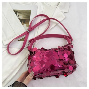 Detail of rose purple sequins on fashion handbag with adjustable leather shoulder strap