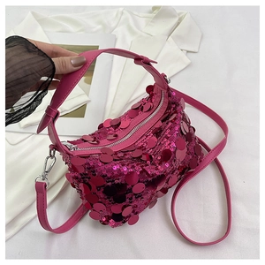 Close-up of vibrant pink sequin handbag showing detailed reflective texture and silver zipper