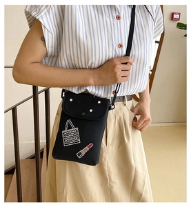 Crossbody phone bag with rhinestone lipstick design worn by a model on stairs