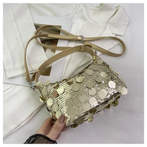 Close-up of golden sequins and adjustable strap on a sparkling stylish evening bag