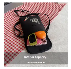 Internal capacity of mini crossbody bag showing phone and sunglasses storage space