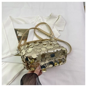 Detail of shimmering gold sequins on a crossbody bag with adjustable khaki shoulder strap