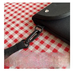 Detail of durable black nylon shoulder strap with heavy-duty clip and silver metal rivet