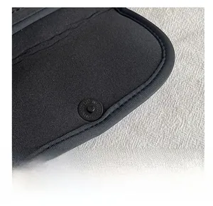 Close-up of premium magnetic buckle and fabric texture on a black summer crossbody bag