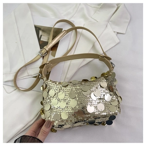 Detailed view of shimmering gold sequins on a stylish crossbody bag with an adjustable strap
