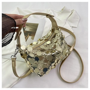 Detailed shot of golden sequins and adjustable strap on a sparkling evening crossbody bag