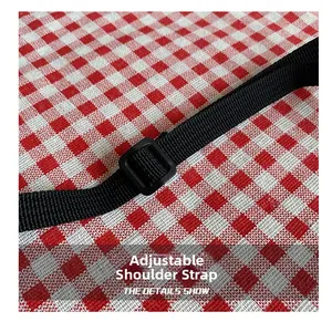 Detail view of adjustable black nylon shoulder strap with durable plastic buckle