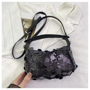 Close-up of black sequin handbag with large mirror sequins and adjustable shoulder strap