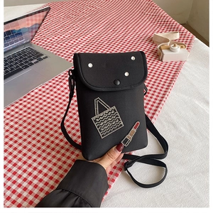 Detail of a black mini crossbody phone bag featuring rhinestone lipstick and bag motifs