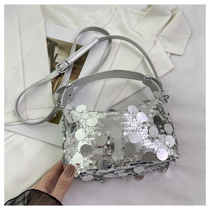 Close-up of silver sequin handbag with metallic texture and sleek leather shoulder strap