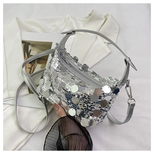 Close-up of a silver sequin handbag featuring a metallic finish and a secure zipper closure