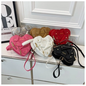 Detail view of heart-shaped biker cross-body bags in six different matte leather colors