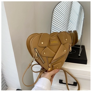 Detail of heart-shaped motorcycle style shoulder bag with zipper and button accents