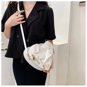 Close-up of white heart-shaped crossbody bag featuring biker jacket zipper details