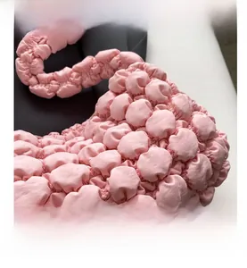 Detailed macro view of the pink bubble textured fabric on this stylish shoulder bag