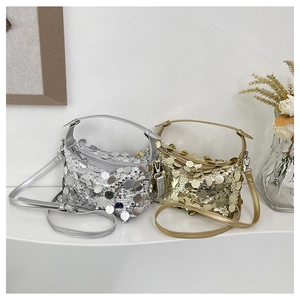 Detail of silver and gold sequin tote bags featuring metallic luster and zipper closure