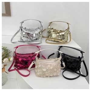 Detail view of sparkly sequin handbags in five metallic colors with elegant top handles
