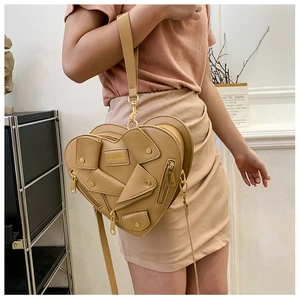 Detail of khaki heart-shaped moto jacket bag featuring zippers and AYWG embossed logo