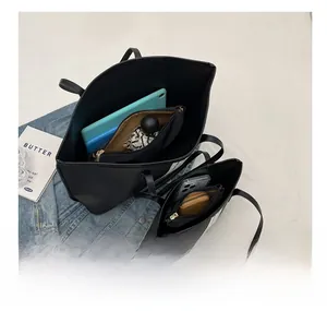 Macro view of interior storage capacity in black nylon tote bag for tablet and essentials