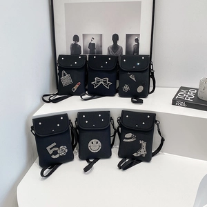 Collection of black fabric mini crossbody phone bags with unique rhinestone patterns