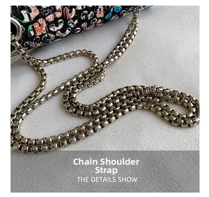 Macro shot of durable gunmetal chain strap and graffiti pattern on a women shoulder bag