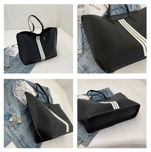 Detail shots of large black tote bag with white stripes and smooth leather texture