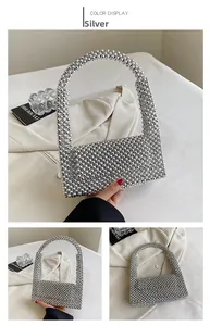 Detail view of a silver beaded punk style handbag with metallic reflective texture