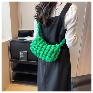 Detail of the bright green pleated bubble shoulder bag with a unique silky textured finish