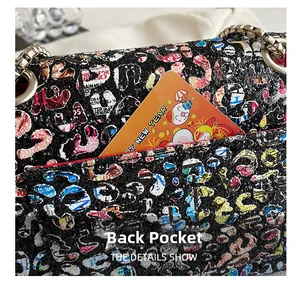 Detail showing the functional back pocket of a graffiti chain bag with festive card