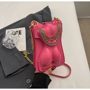Close-up of pink sculptural torso small square bag with metallic chain and embossed details
