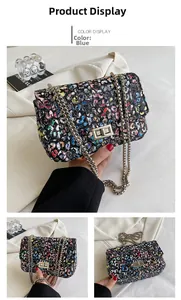 Detail of blue leopard print bag with metal chain strap and rectangular turn-lock