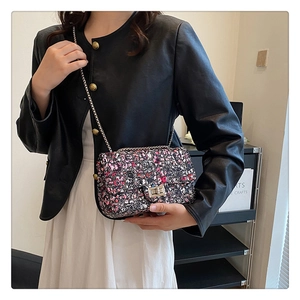 Detail of multi-color tweed bag with silver metal chain and rectangle twist lock
