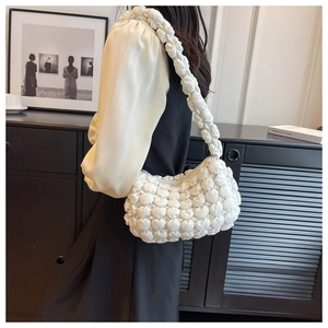 White bubble textured shoulder bag with pleated straps shown on a model for a casual look