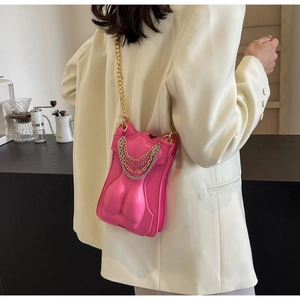 Detail of rose red creative body-shaped crossbody bag with gold chain straps