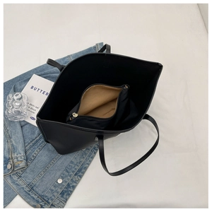 Interior view of black nylon tote bag showing inner zipper pouch and spacious storage