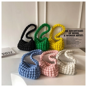 Detailed view of bubble texture hobo bags in six vibrant colors displayed on stairs